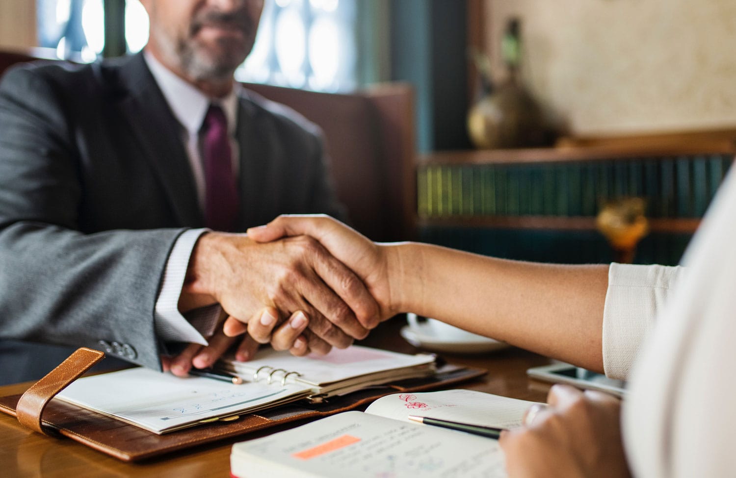 Legal consultation and handshake at a desk
